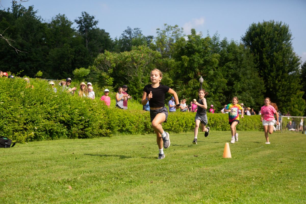 Children running in a race on the lawn
