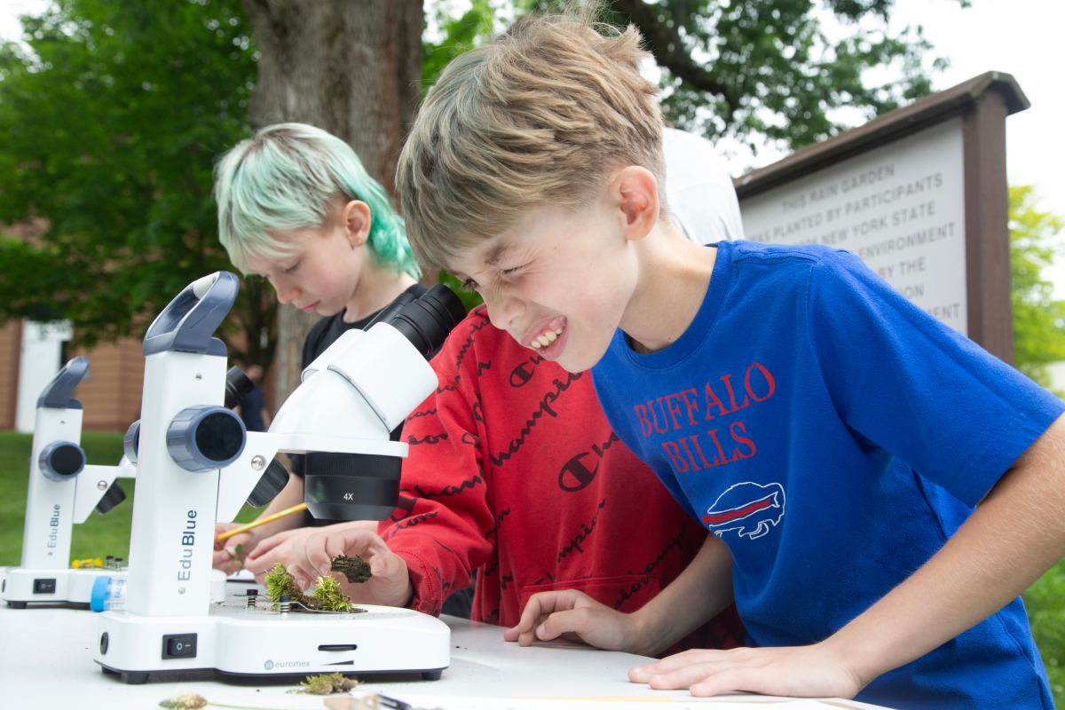 Children using microscopes outdoors